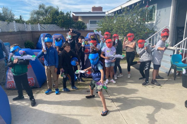 a group of people standing in front of a crowd posing for the camera