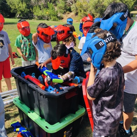 a group of people standing next to a dog