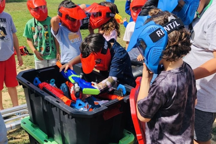 a group of people standing next to a dog