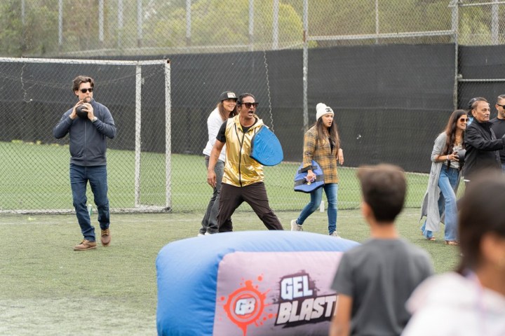 a group of people sitting around a baseball field
